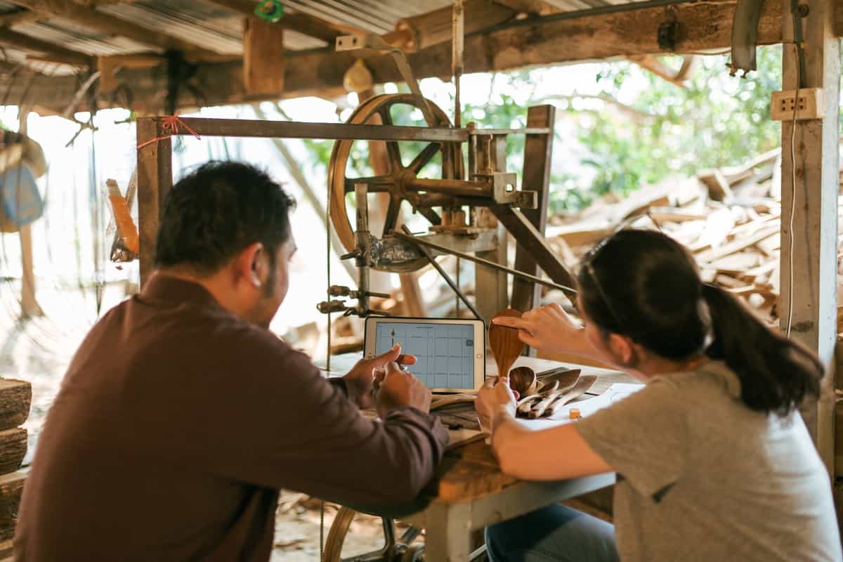 FAAY HAUS community artisan shaping a wooden object