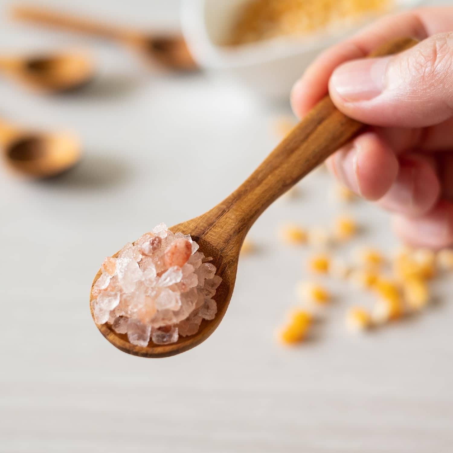 Himalayan pink salt in spoon, natural mineral salt, healthy cooking ingredient, salt for wellness.