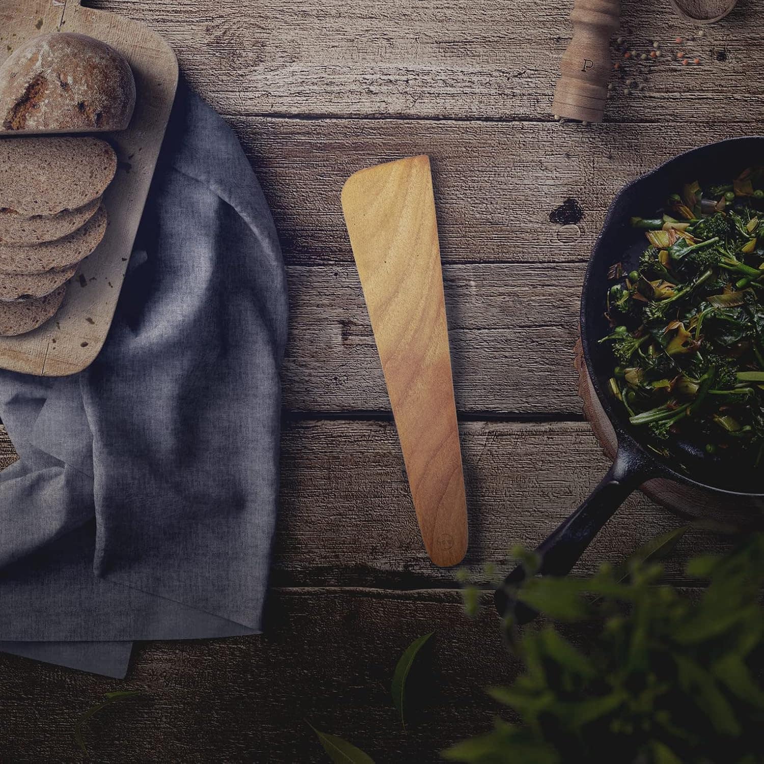 Healthy food ingredients with homemade bread and sautéed greens.