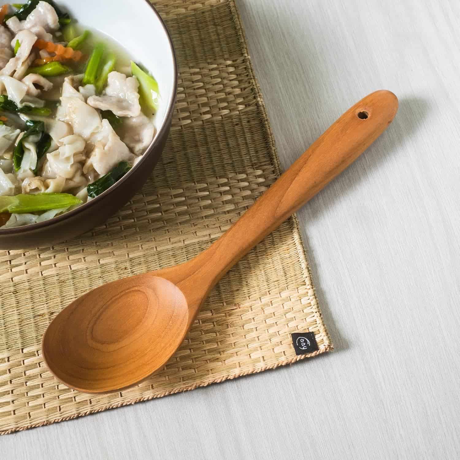 Natural wooden kitchen utensil for cooking and serving.